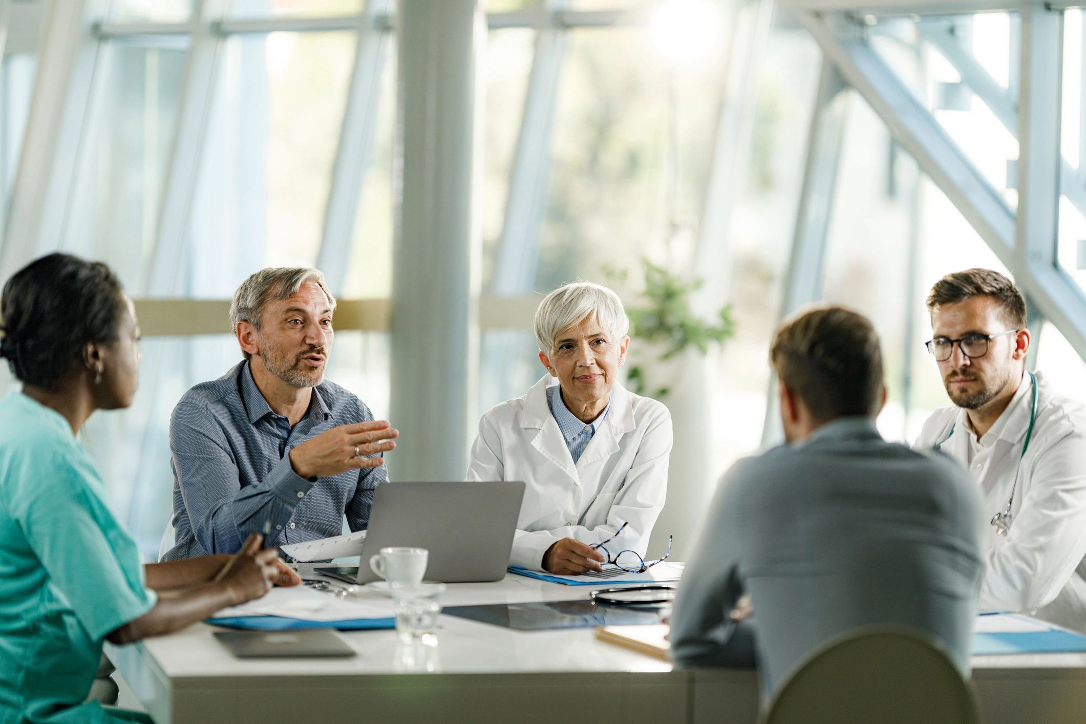 Team members in a meeting at a clinic office